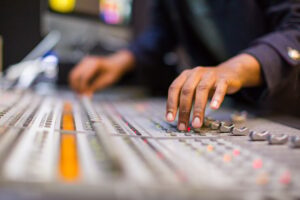 Audio visual sound mixer hands control buttons adjsuting Kenya East Africa